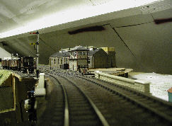 Northbound view with home and distant on a wooden post